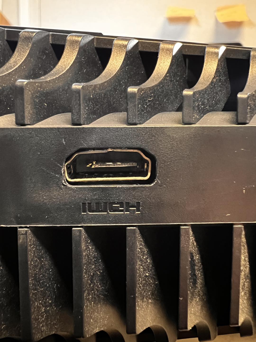 Close-up of a snapped/damaged HDMI port still on a console board — the why you're here shot