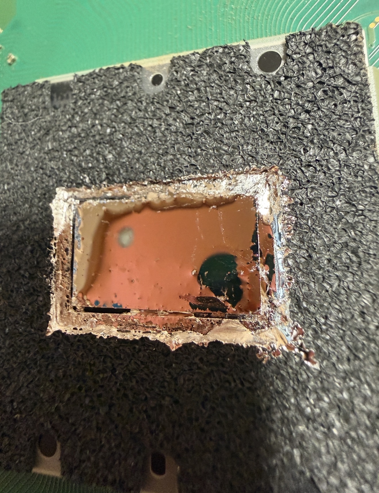 Fresh liquid metal applied cleanly across the PS5 APU