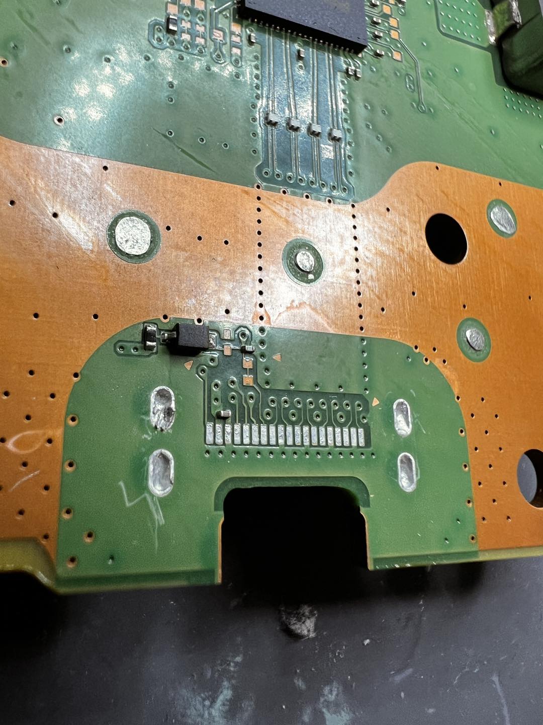 PS5 board with damaged HDMI port removed, pads cleaned ready for new port