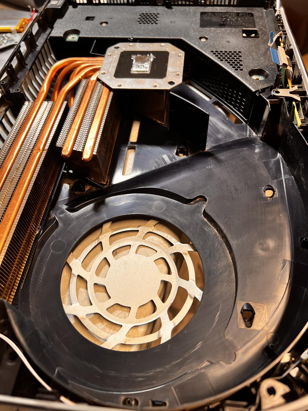 Same PS5 after strip and clean — spotless heat sink, fresh liquid metal on APU