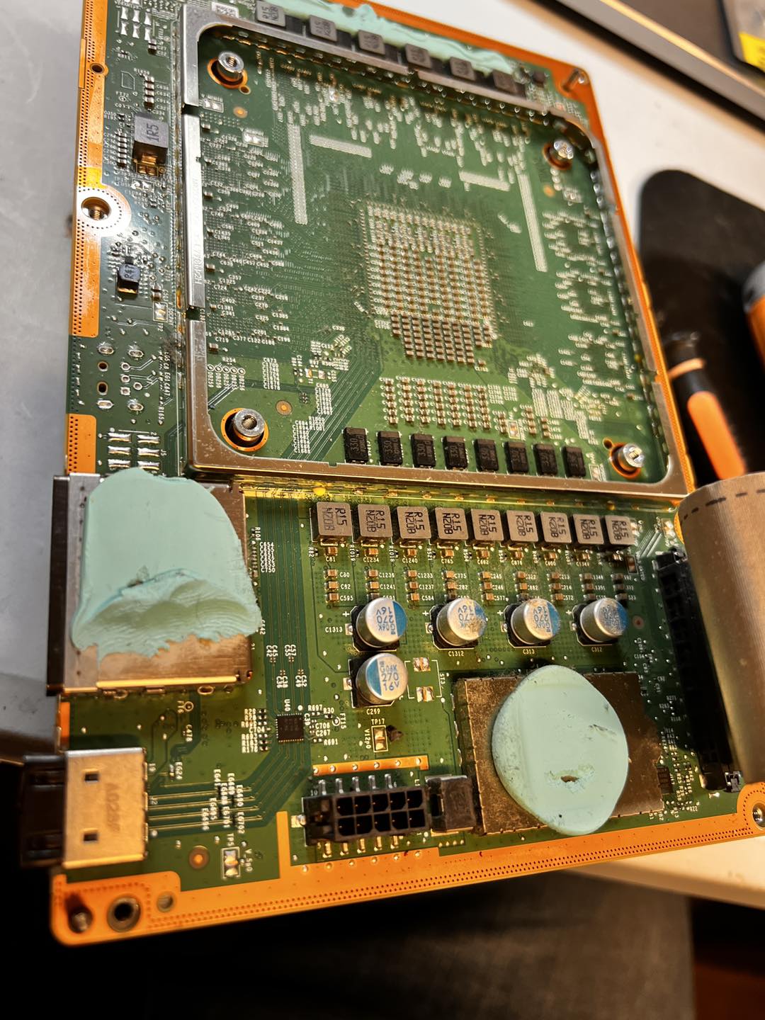 Xbox Series X or S motherboard open on the workbench, HDMI port area visible