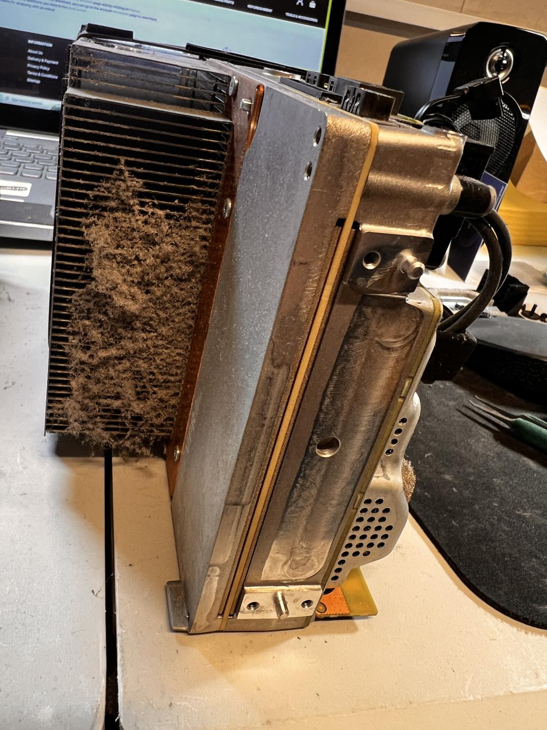 Dust-packed Xbox heat sink and fan housing — proof of why overheating happens